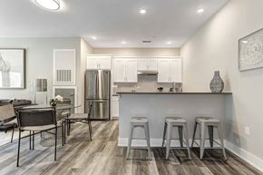 Newburgh apartment for rent - a kitchen and dining room with a bar and a refrigerator
