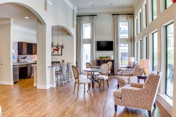 Tomball apartment for rent - A living room with a large couch and chairs.