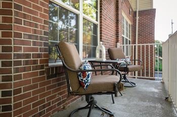 Two chairs are placed on a patio 