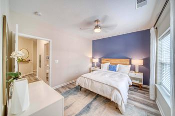 A bedroom with a bed and a desk