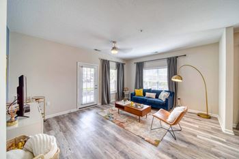 A living room with a blue couch and a coffee table