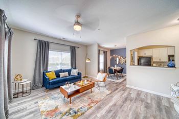 A living room with a blue couch and a coffee table