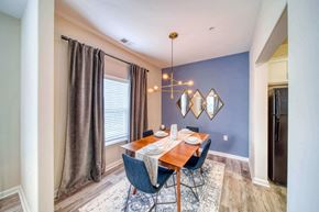 Suffolk apartment for rent - a dining room with a table and chairs and a chandelier at Meridian Obici, Suffolk