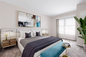 West Hempstead apartment for rent - a bedroom with a large painting on the wall and a bed with a blue blanket at West 130, West Hempstead, NY