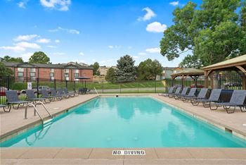 A pool with a no diving sign in the foreground.