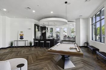 A game room with a pool table and a bar