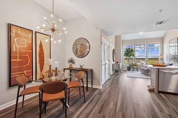 A dining room and living room with a table and chairs