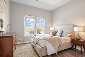Hempstead apartment for rent - a bedroom with a bed and two windows at Metro 303, Hempstead, NY