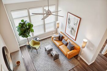 An overhead view of a living room with a couch and a ceiling fan
