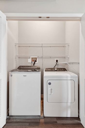 A small laundry room with two washes and a dryer