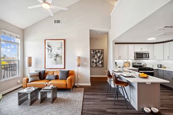 A living room with a couch and a kitchen with a table