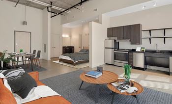 A modern living room with a kitchen area in the background.