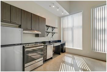 A modern kitchen with stainless steel appliances and wooden cabinets.