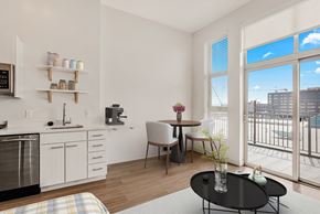 Denver apartment for rent - A kitchen with a refrigerator, sink, and coffee maker at RiDE at RiNo Apartments, Colorado, 80216