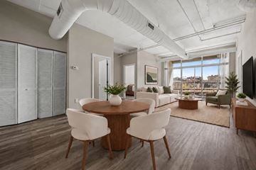 Baltimore apartment for rent - A modern living room with a dining table and chairs.