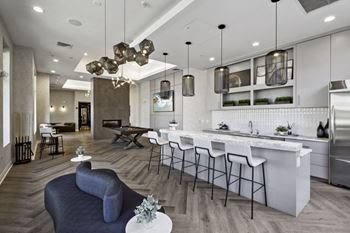 A living room with a kitchen and a dining room