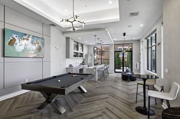 A game room with a pool table and a bar