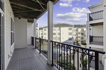 A balcony with a view of a building and a balcony fence