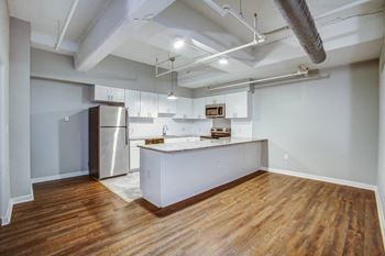 A kitchen with a refrigerator and a countertop.