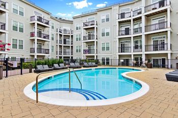 A swimming pool in front of an apartment building