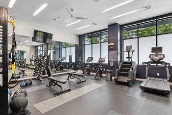 A gym with cardio equipment and weights