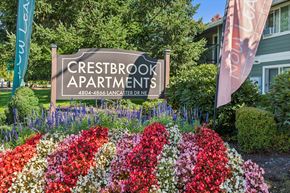Salem apartment for rent - A sign for Crestbrook Apartments is displayed in front of a flower bed.