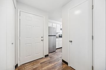 Keizer apartment for rent - A kitchen with white cabinets and a white door.