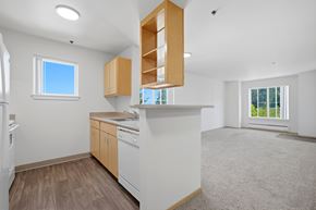 Portland apartment for rent - A kitchen with white appliances and wooden cabinets.