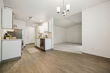Keizer apartment for rent - A kitchen with white cabinets and a wooden floor.