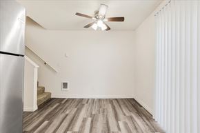 Milwaukie apartment for rent - A room with a ceiling fan and wooden flooring.