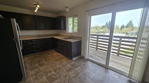 Portland apartment for rent - A kitchen with black cabinets and a tiled floor.
