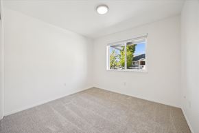 Salem apartment for rent - A room with a carpeted floor and a window showing a house and trees outside.