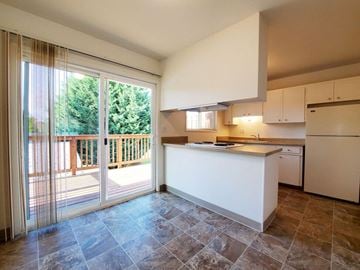 Beaverton apartment for rent - A kitchen with a white counter and brown tiles.