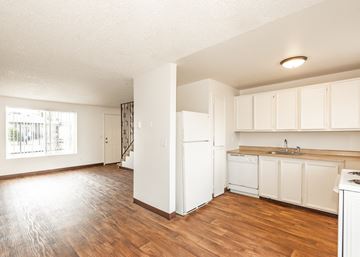 Oregon City apartment for rent - A kitchen with white cabinets and a wooden floor.