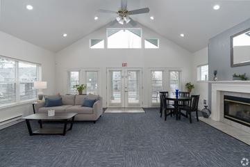 Aloha apartment for rent - A living room with a grey carpet and a fireplace.