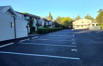 Portland apartment for rent - A parking lot with numbered parking spaces.