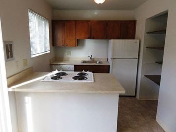 Beaverton apartment for rent - A kitchen with white countertops and a white refrigerator.