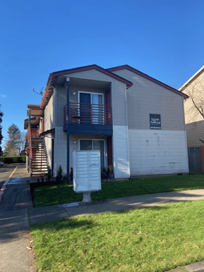 Hillsboro apartment for rent - A two-story apartment building with a garage door on the first floor.