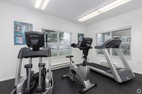 Aloha apartment for rent - A gym with a treadmill and elliptical trainer.