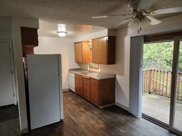 Vancouver apartment for rent - A kitchen with wooden cabinets and a white refrigerator.