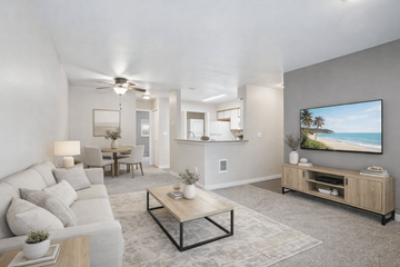 Beaverton apartment for rent - A modern living room with a grey sofa, a wooden coffee table, and a large painting on the wall.
