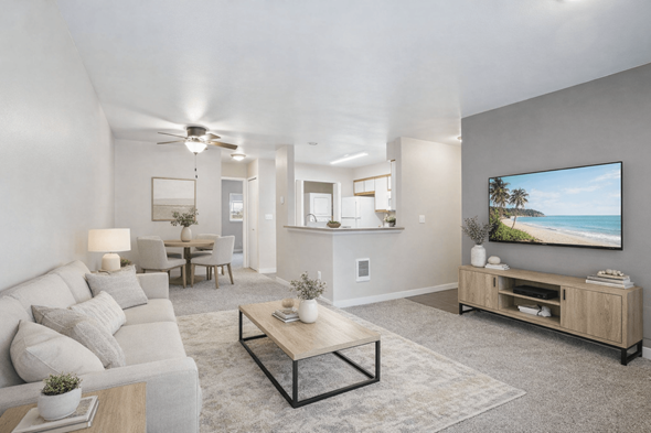 Beaverton apartment for rent - A modern living room with a grey sofa, a wooden coffee table, and a large painting on the wall.