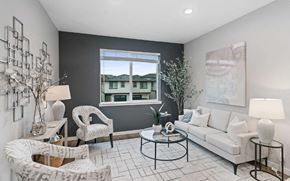 Salem apartment for rent - A living room with a white couch, a black coffee table, and a large window.