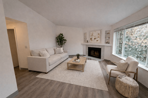 Tualatin apartment for rent - A living room with a white couch, a coffee table, and a fireplace.