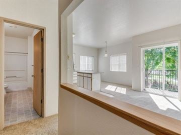 Gresham apartment for rent - an open living room and kitchen with a door to a balcony