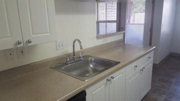 Gresham apartment for rent - A kitchen with a sink and cabinets.
