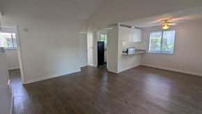 Scappoose apartment for rent - A spacious living room with hardwood floors and white walls.
