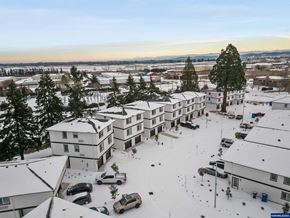 Salem apartment for rent - A snowy landscape with apartment buildings and cars.