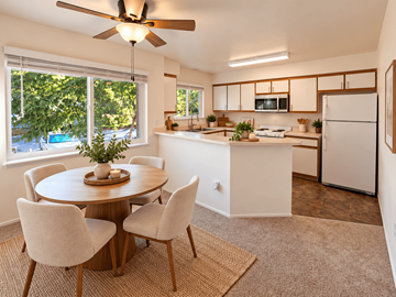 Beaverton apartment for rent - A kitchen with a table and chairs in the foreground and a refrigerator in the background.