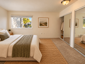 Beaverton apartment for rent - A bedroom with a large bed and a carpeted floor.